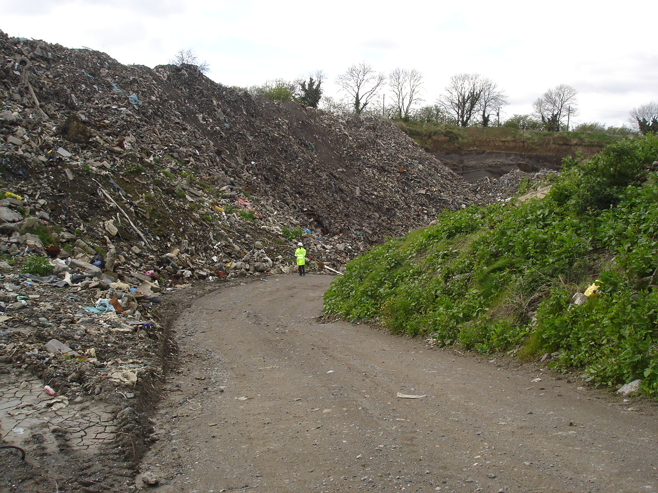 illegal landfill image with EPA staff member in background