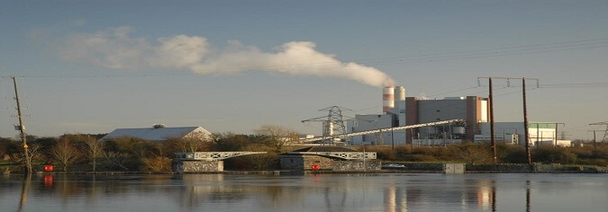 image of a factory with smoke coming out of the chimney