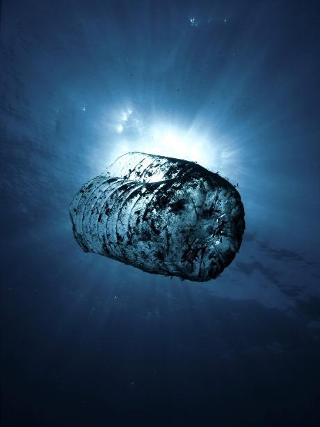 Half plastic bottle in the ocean