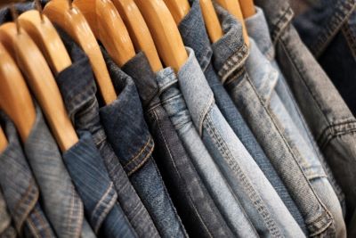 A rail of denim shirts on hangers