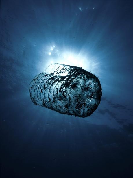 Half plastic bottle in the ocean