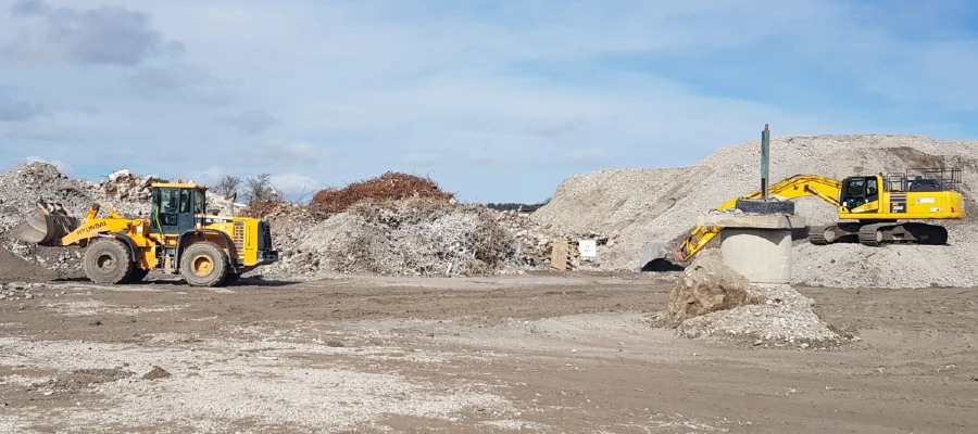 Photo of two diggers on a construction & demolition waste site